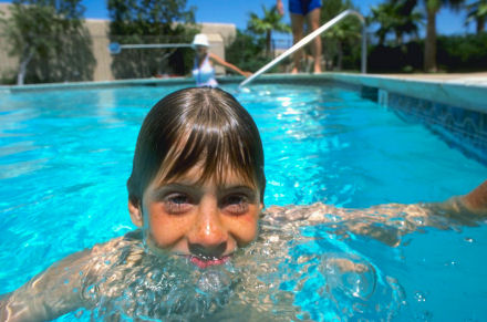Boy at pool side enjoying water