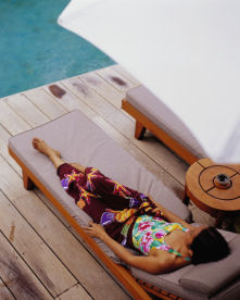 Woman relaxing on chase lounge.